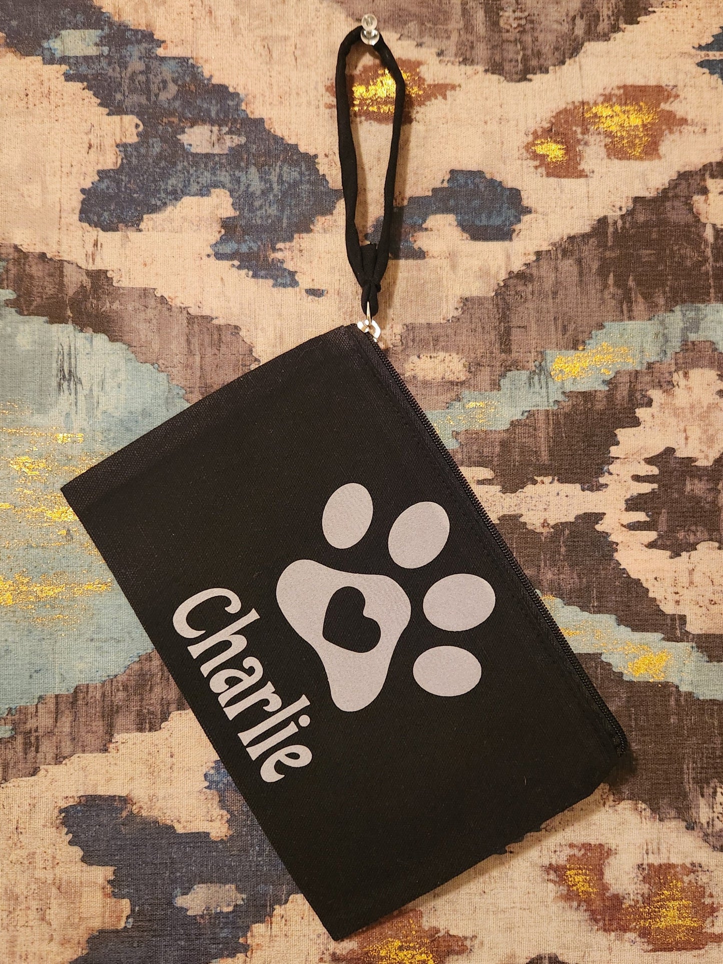Keep track of your fur baby's items or represent someone you love so much with this cute canvas zipper pouch. The pouch will be personalized with your fur-baby's name. 

Dimensions and material:

Black canvas material

Length: 6 5/8"
Width: 10"