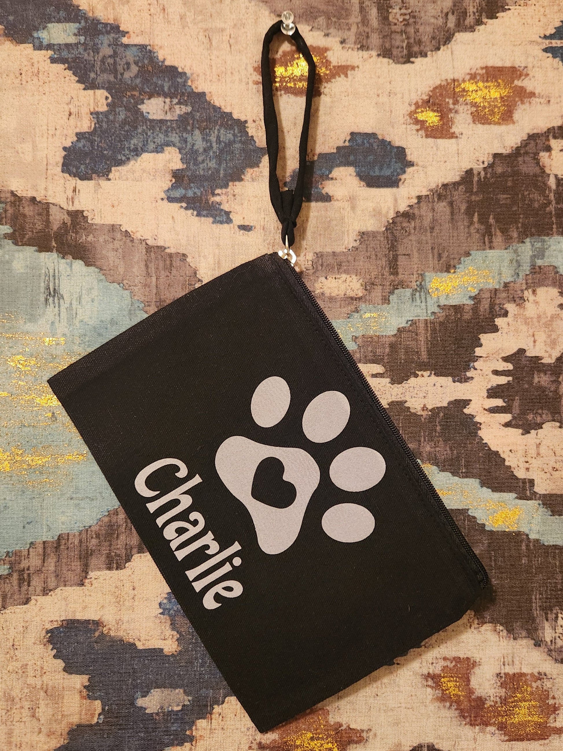 Keep track of your fur baby's items or represent someone you love so much with this cute canvas zipper pouch. The pouch will be personalized with your fur-baby's name. 

Dimensions and material:

Black canvas material

Length: 6 5/8"
Width: 10"