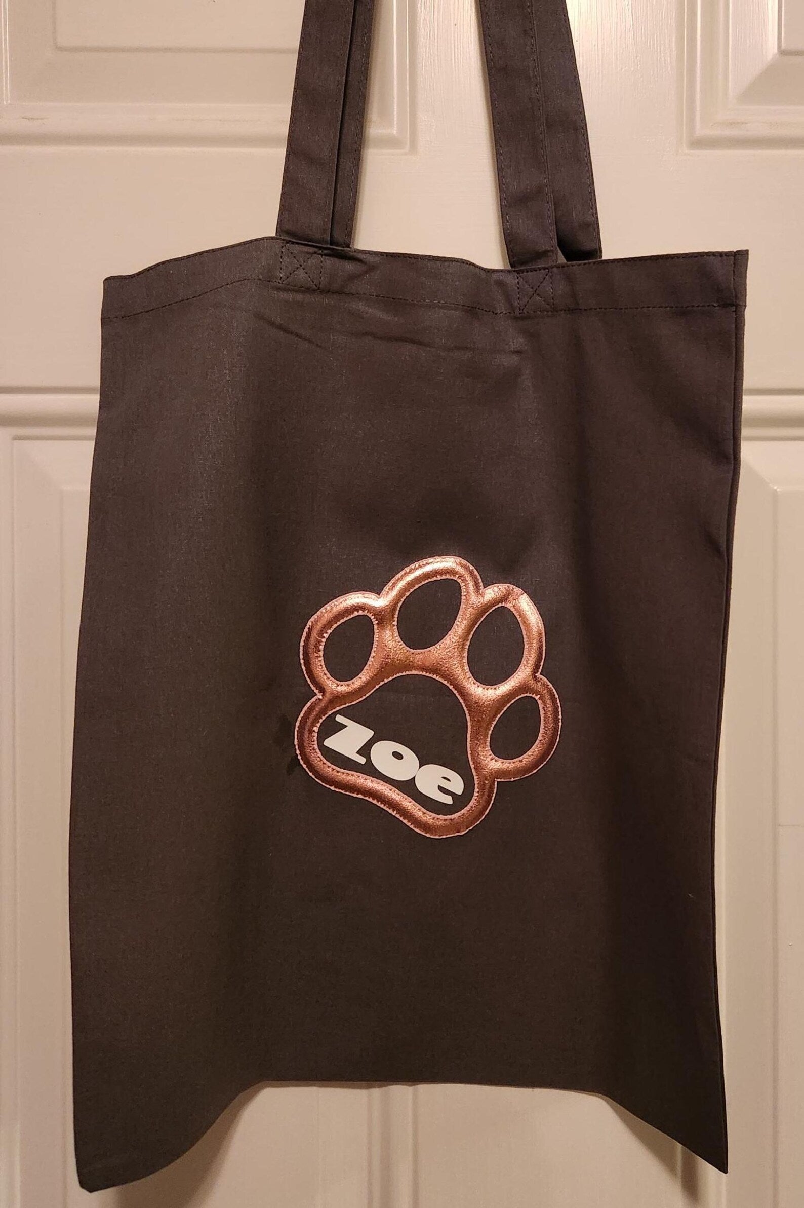 The grey-lightweight reusable tote made of cotton can be customized with your fur babies name.  This is great for transporting you fur-kids supplies or to carry your items for a quick run to grocery store. 

Dimensions: 
 15" x 16" (38 x 40.6cm)